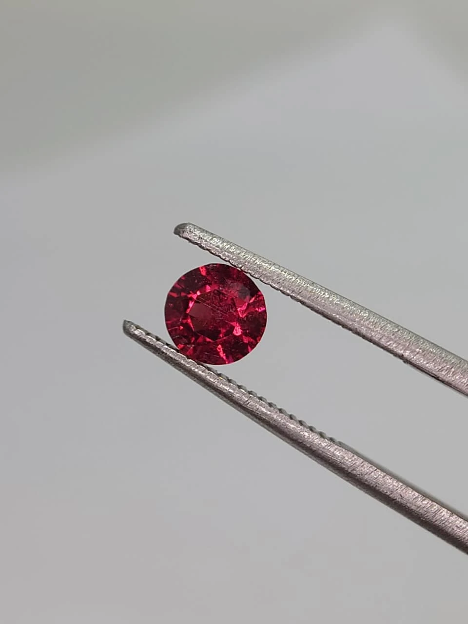 0.6ct Natural Round Faceted Malaya Garnet from Tanzania — view 2